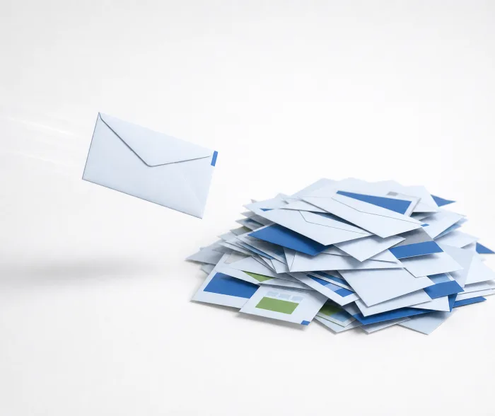 A generic envelope flying toward a discarded pile of unwanted mail