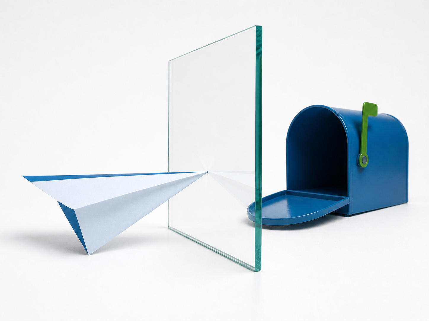 A paper airplane stopped by a glass barrier before reaching an open mailbox